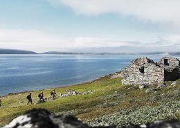 Hikers approaching Hvalsey church ruin one of several norse historical sites in south greenland. By David Trood