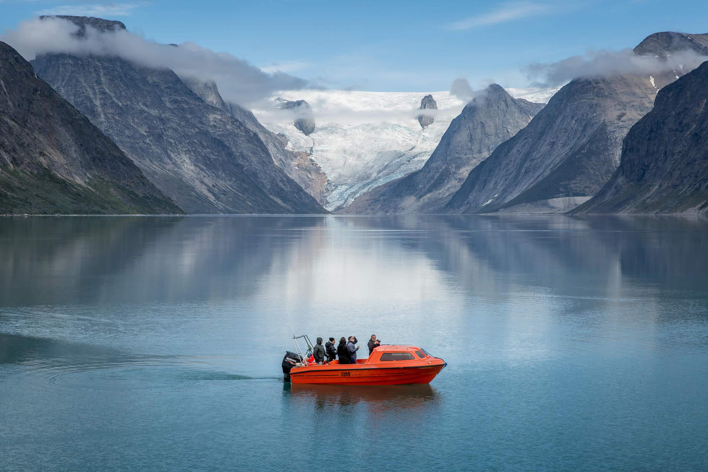 A small passenger boat near the bottom of the Tasermiut fjord in South Greenland. Photo by Mads Pihl - Visit Greenland