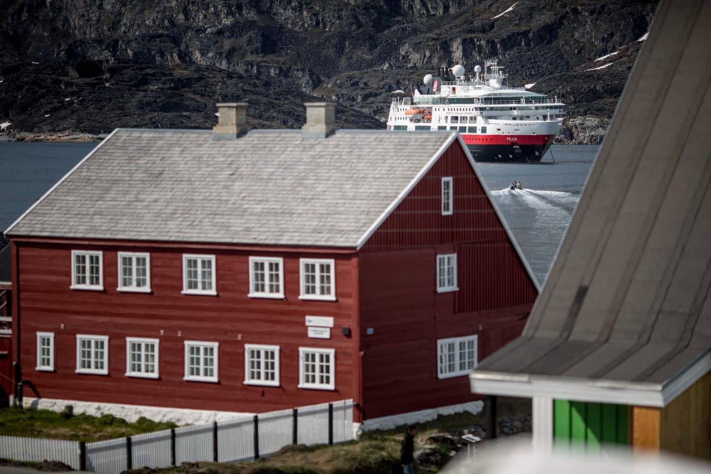 MS Fram behind old building in Qeqertarsauq in Greenland. Photo by Mads Pihl.