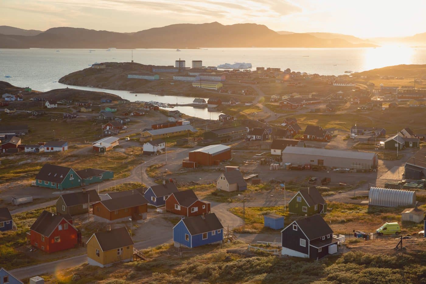 The sun sets over Narsaq in South Greenland. .Photo by Mads Pihl