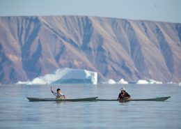 Two boys in Inuit kayaks, Qaanaaq. Photo by Glenn Mattsing.