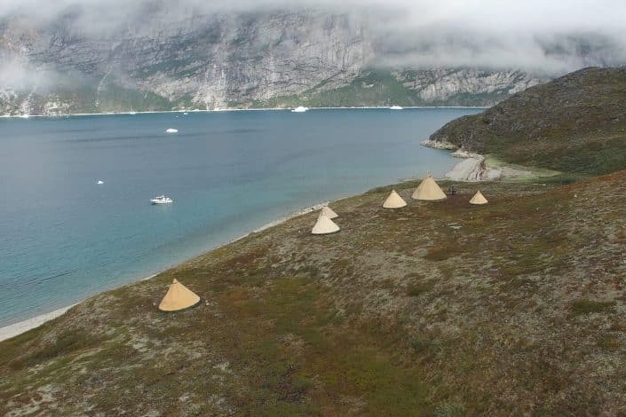 Camp at the waterfront viewed from above. Photo by Arctic Nomad