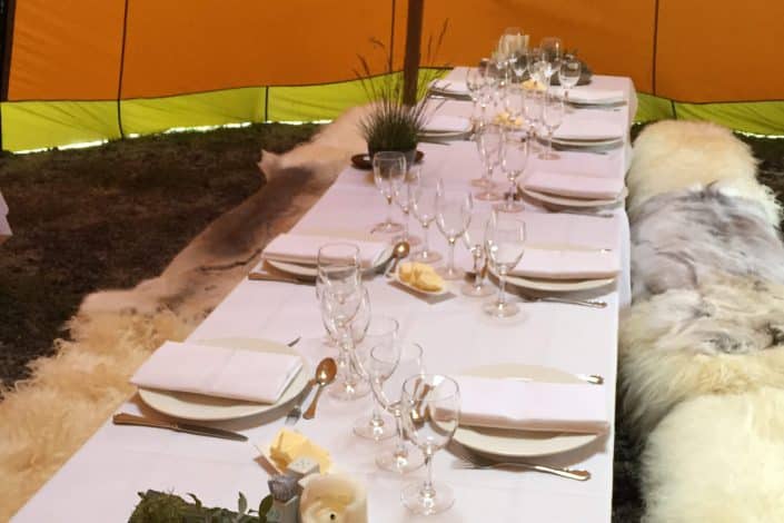 Set table ready for dinner in a comfortable tent. Photo by Arctic Nomad