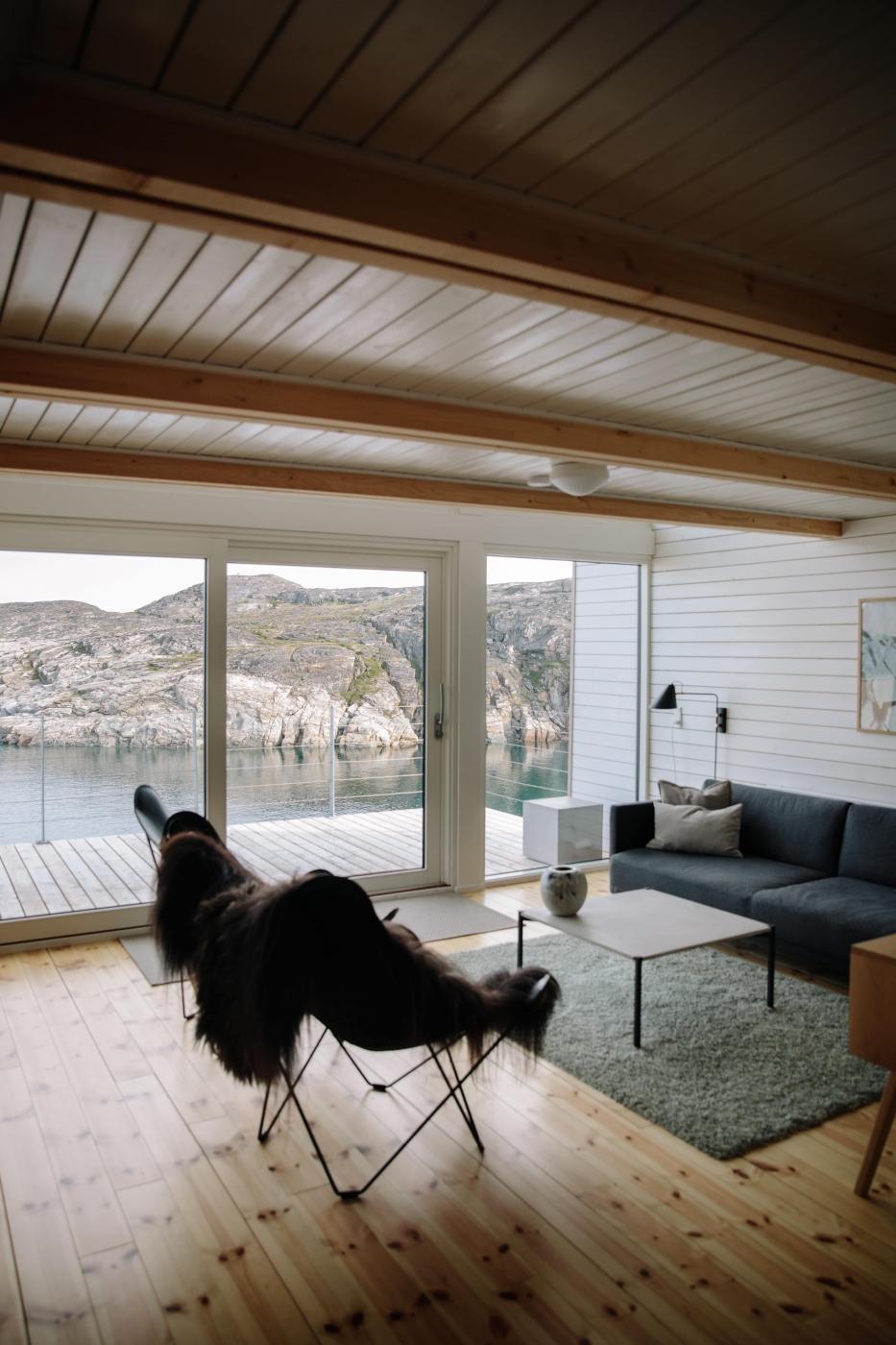 The living room of the hut at Ilimanaq Lodge with ocean views. Photo by Jessie Brinkman Evans