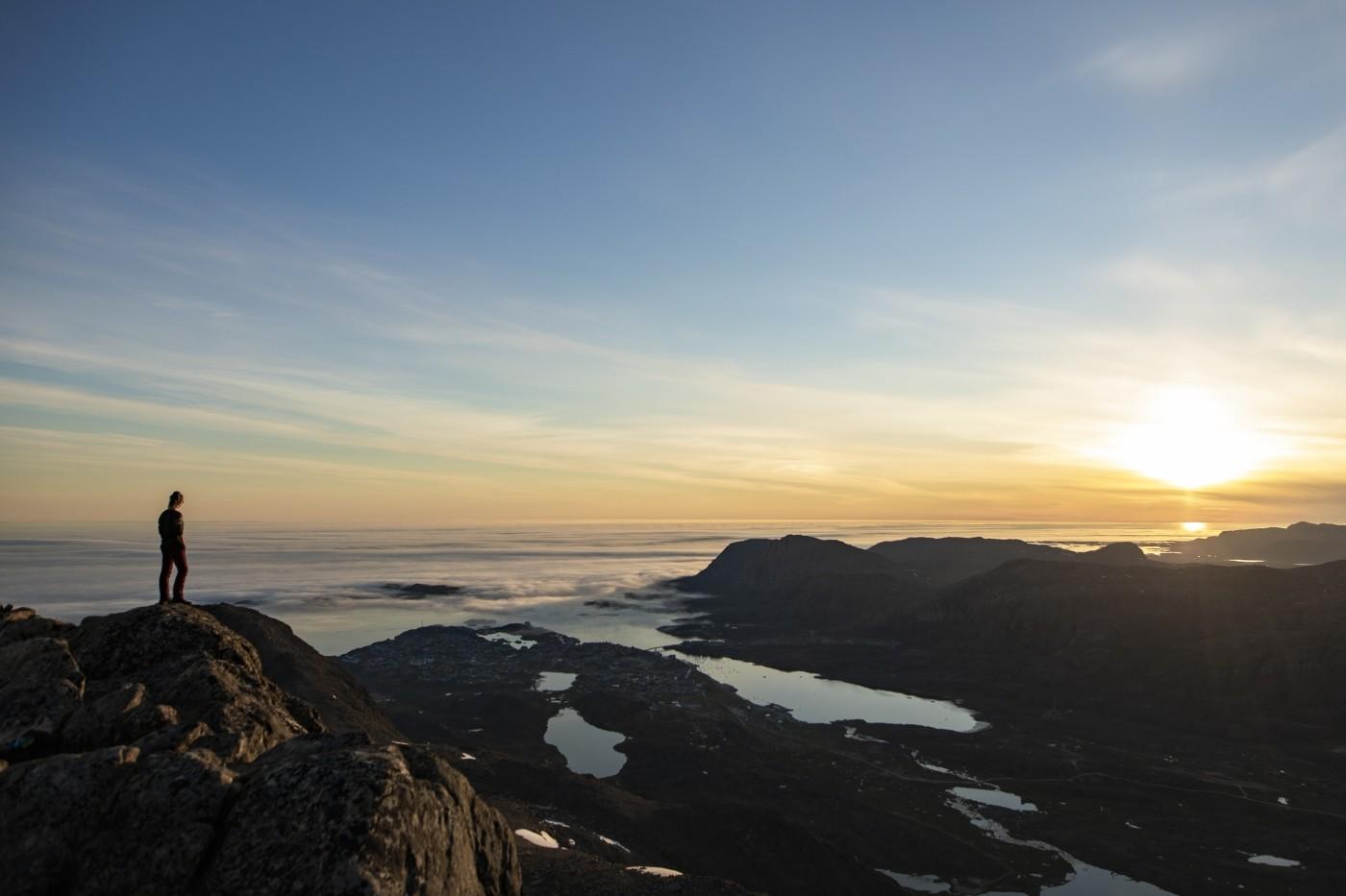 Stand above the clouds at mountain Nasaasaaq. Photo by Aningaaq R Carlsen - Visit Greenland