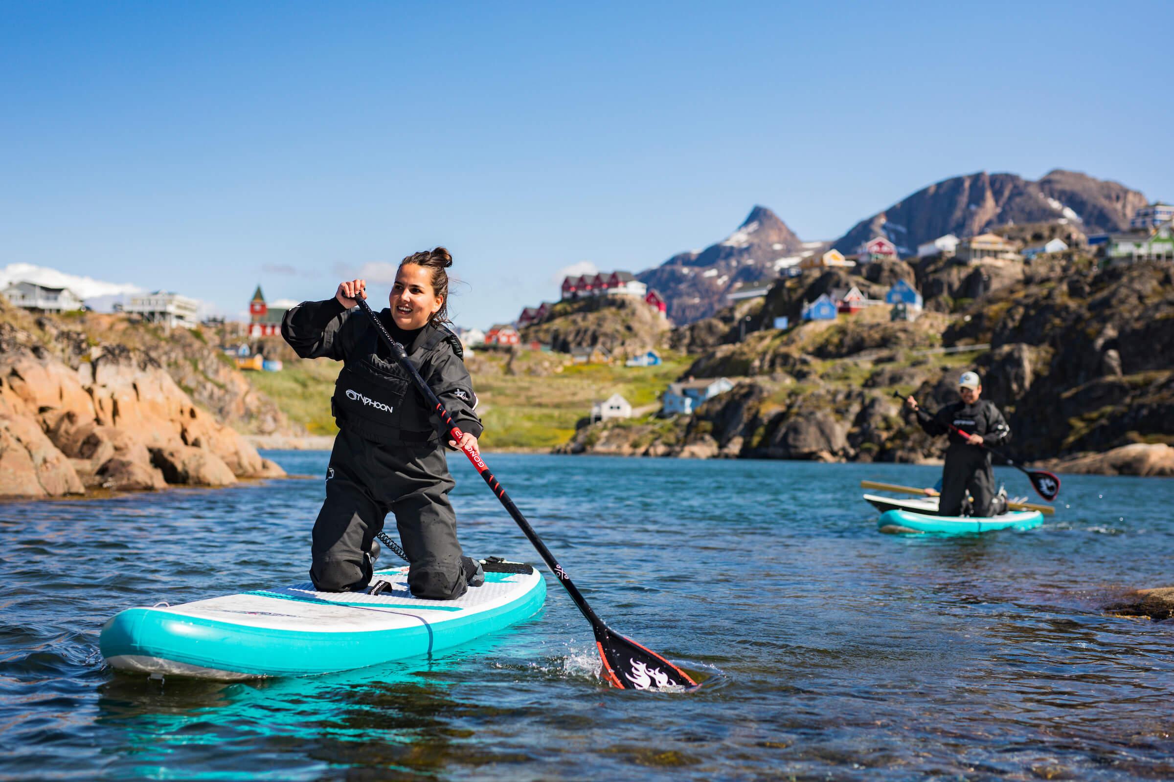 Two SUP with Sisimiut in the back. Photo - Aningaaq R. Carlsen, Visit Greenland