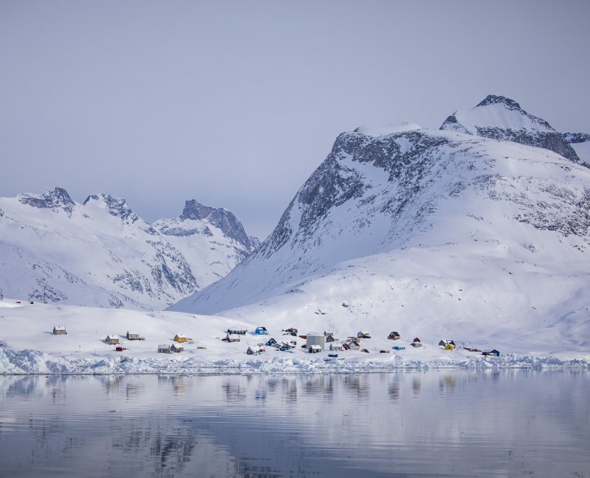 The settlement Tiilerilaaq between towering mountains in winter. Photo by Aningaaq Rosing Carlsen - Visit Greenland