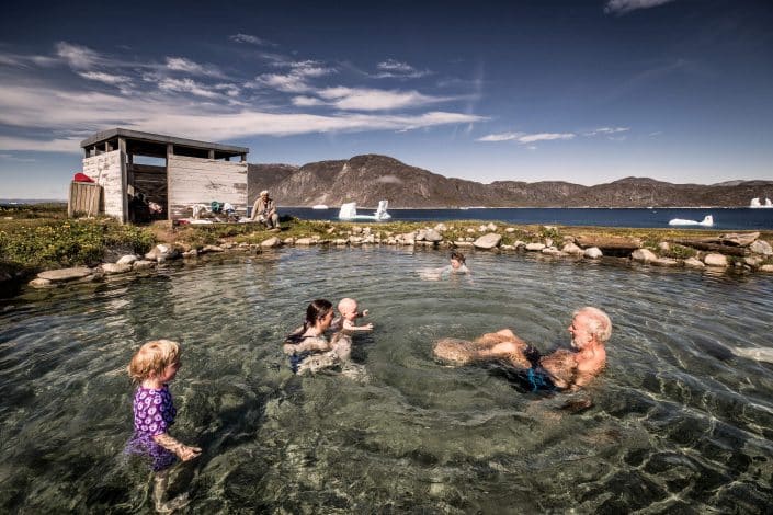 A family enjoying the Uunartoq hot springs in South Greenland. By Mads Pihl