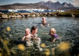 A family visiting Uunartoq Springs in South Greenland