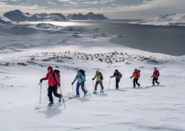 A group of skiers climbing a mountain near Kulusuk on a ski touring trip in East Greenland. Photo by Mads Pihl, Visit Greenland