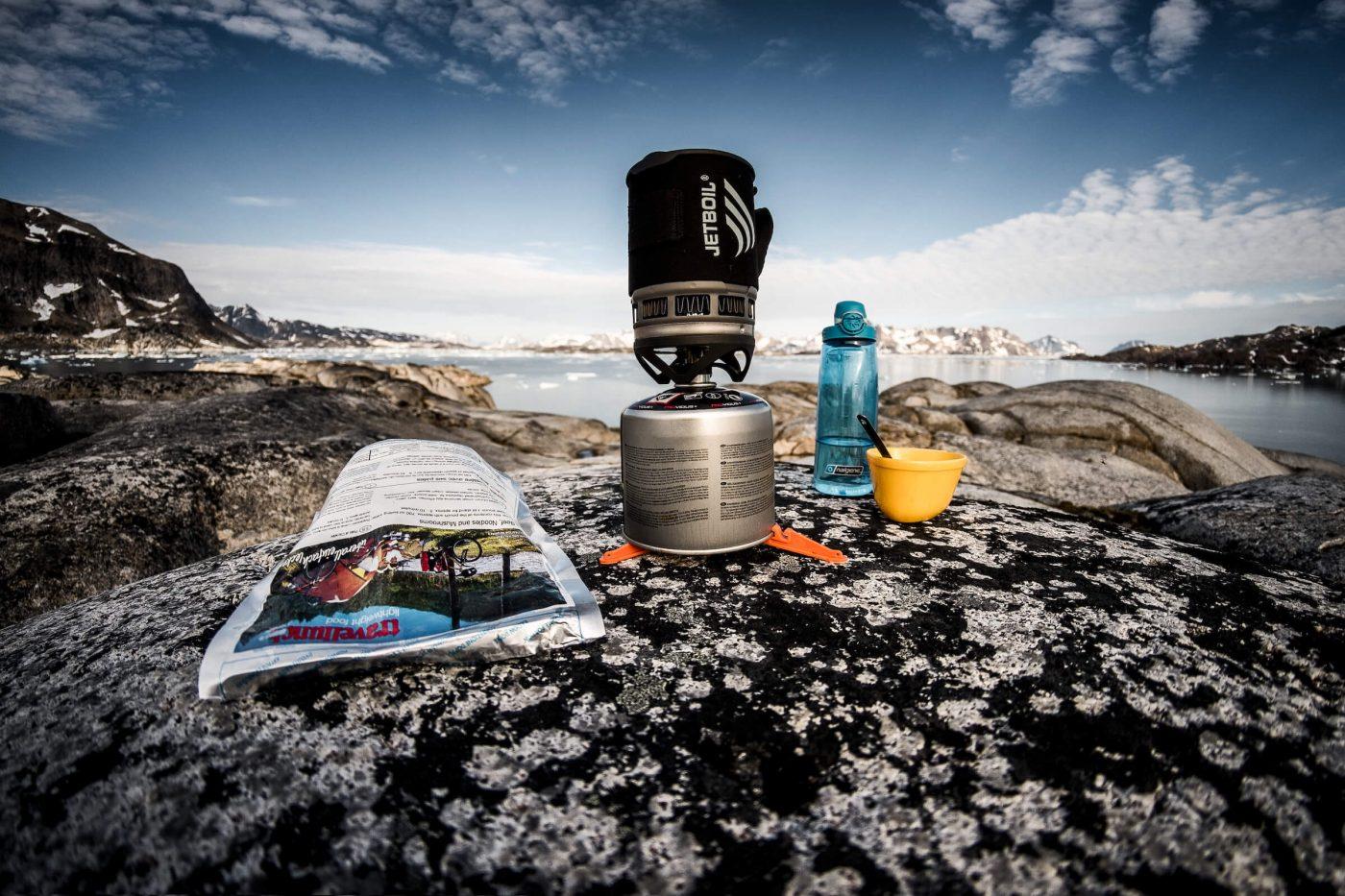Cooking gear and freeze dried food on a rock near Kulusuk in East Greenland. By Mads Pihl