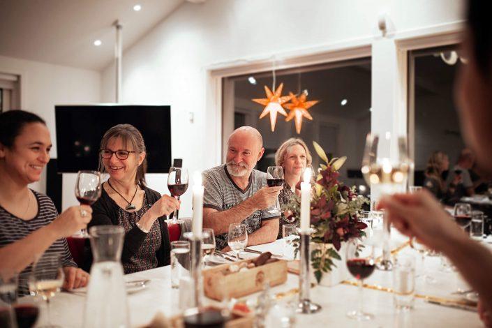 Locals and tourists toasting at a christmas dinner in Nuuk in Greenland. Photo by Rebecca Gustafsson