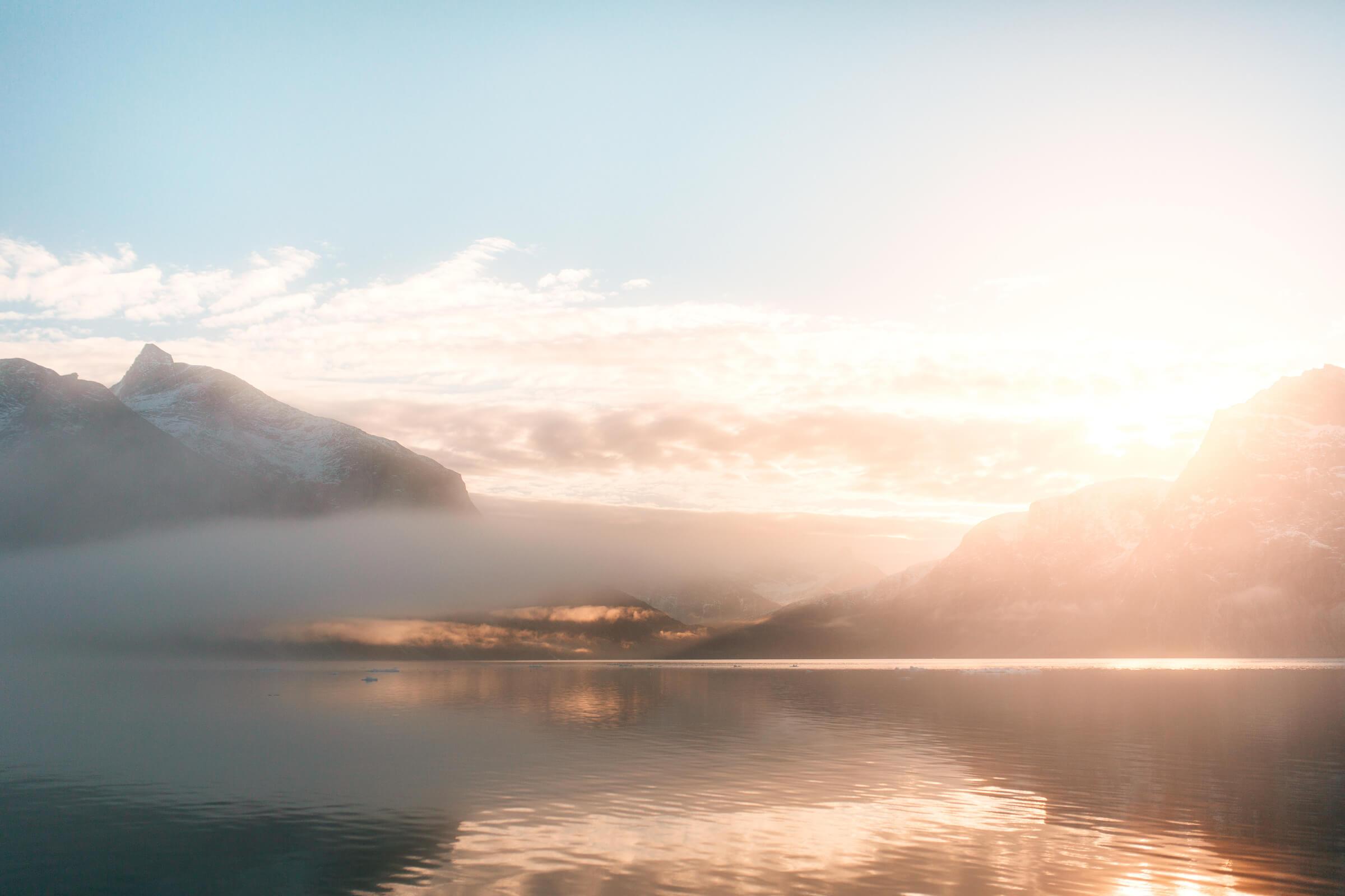 Sunrise over the mountains in the Nuuk fjord in Greenland. Photo by Rebecca Gustafsson
