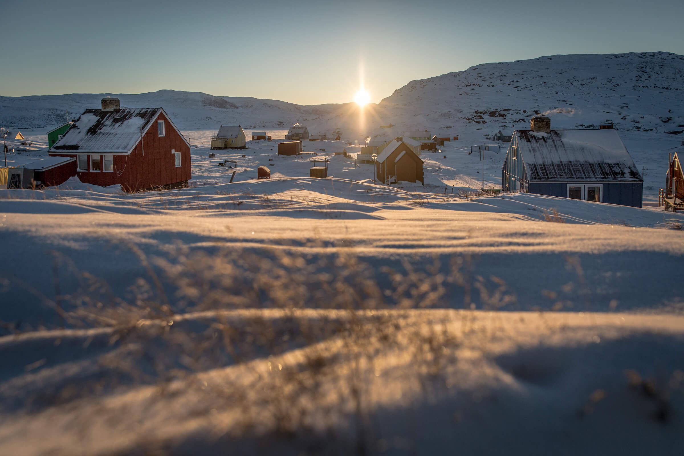 Sunrise over the village Oqaatsut in North Greenland near Ilulissat in the Disko Bay