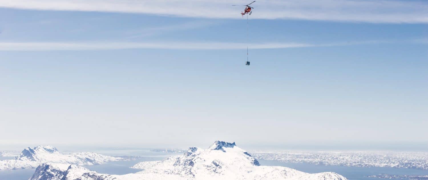 Air Greenland's helicopter transports gasoline tanks over the Sermitsiaq mountain to the top of Qingaaq mountain in Nuuk fjord. Photo by Filip Gielda