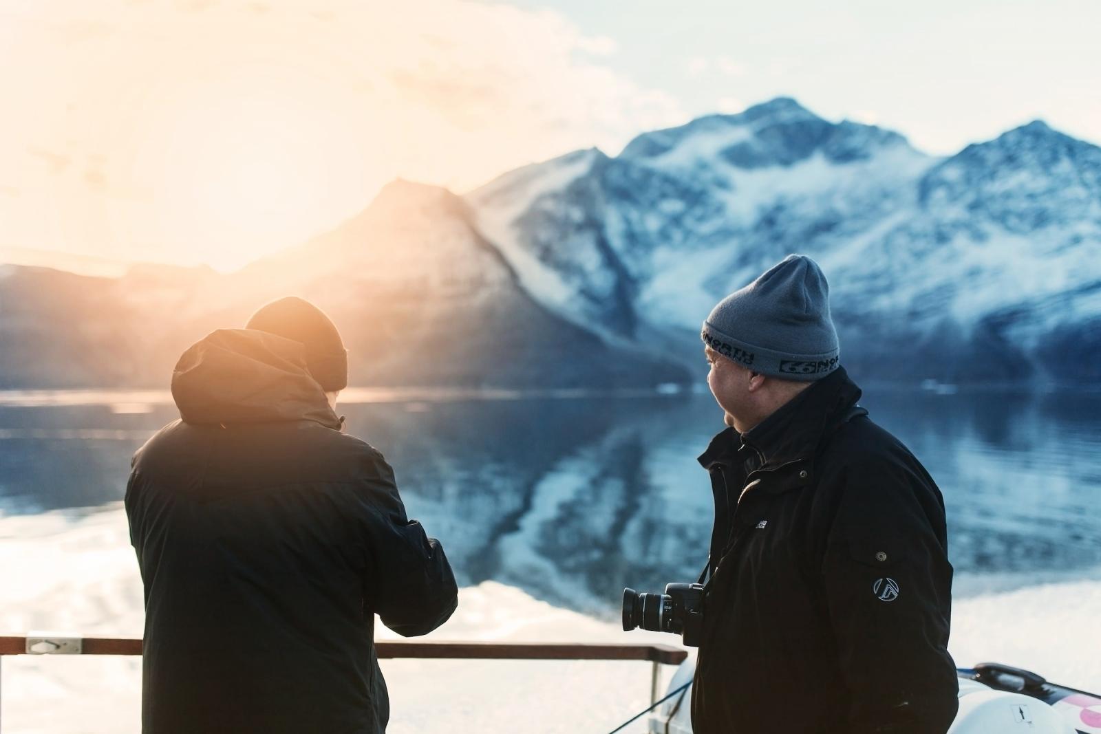 Two men enjoying the sunrise in the Icefjord in Nuuk in Greenland. Photo by Rebecca Gustafsson, Visit Greenland.