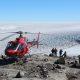 Tourists standing next to a helicopter while looking at the Greenland Ice Sheet. Photo by Arctic Nomad