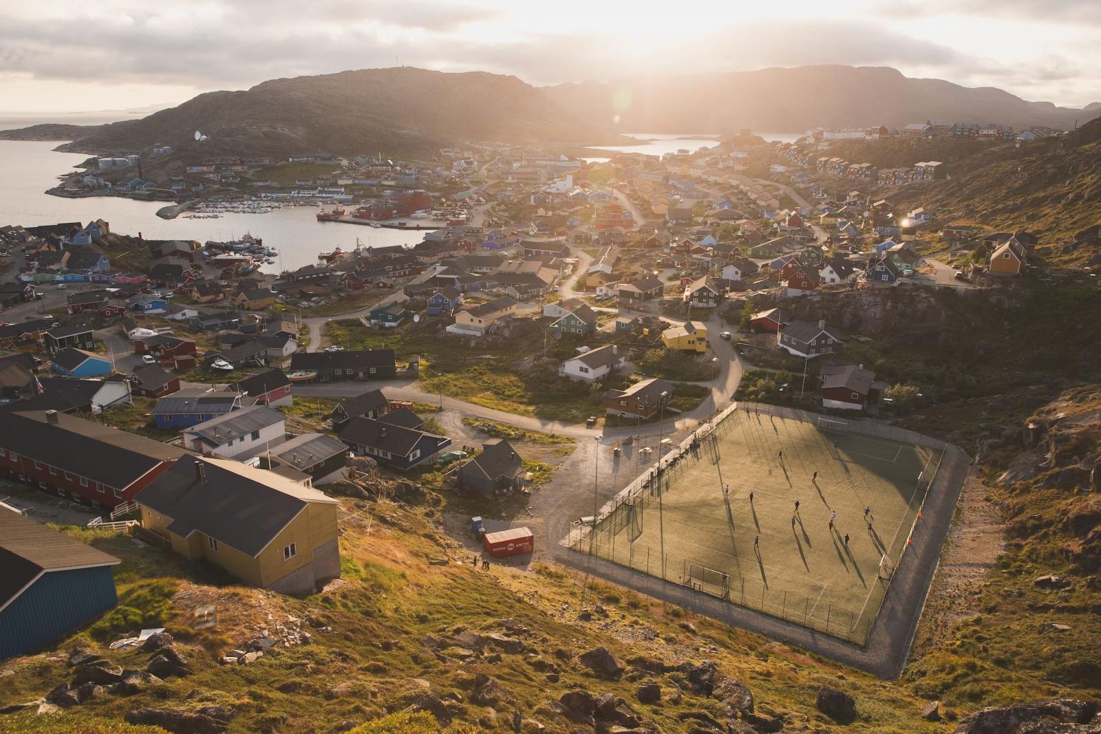Sunset over a game of soccer and Qaqortoq in South Greenland. Photo by Mads Pihl
