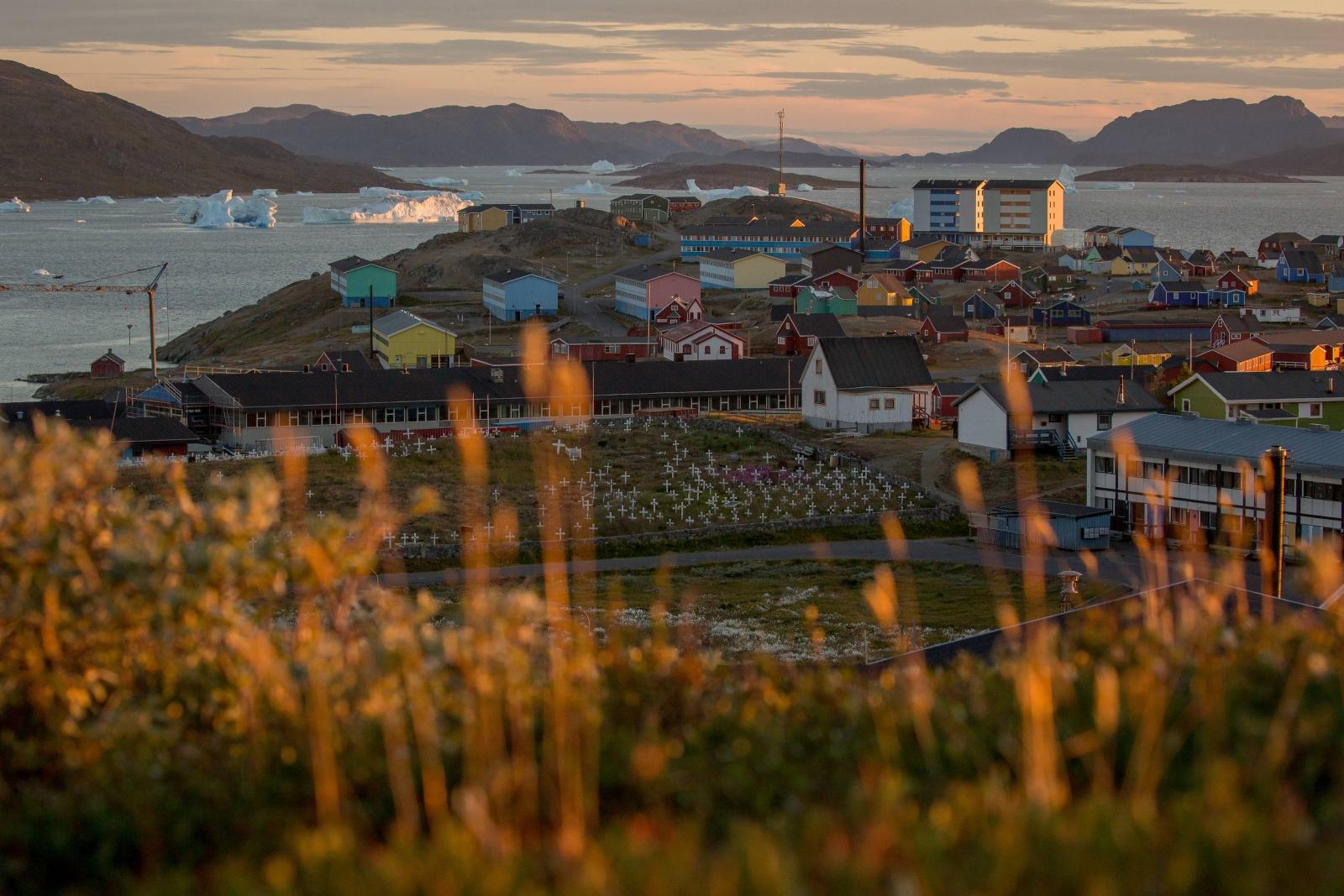 Sunset over Narsaq and the bay with icebergs in South Greenland. Photo by Mads Pihl
