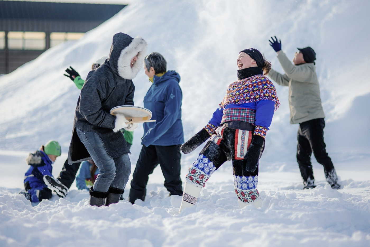 Two people laughing and dancing in Nuuk during a _Happy_ video shoot in Greenland. Photo by Filip Gielda - Visit Greenland