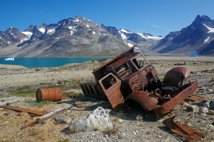 Ruined vehicle with the landscape of Ikkatteq in East Greenland, where the Americans once had a military base. Photo by Reinhard Pantke - Visit Greenland