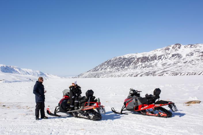 Two snowmobilers on pause in Sisimiut. Photo by Kim Insuk - Visit Greenland