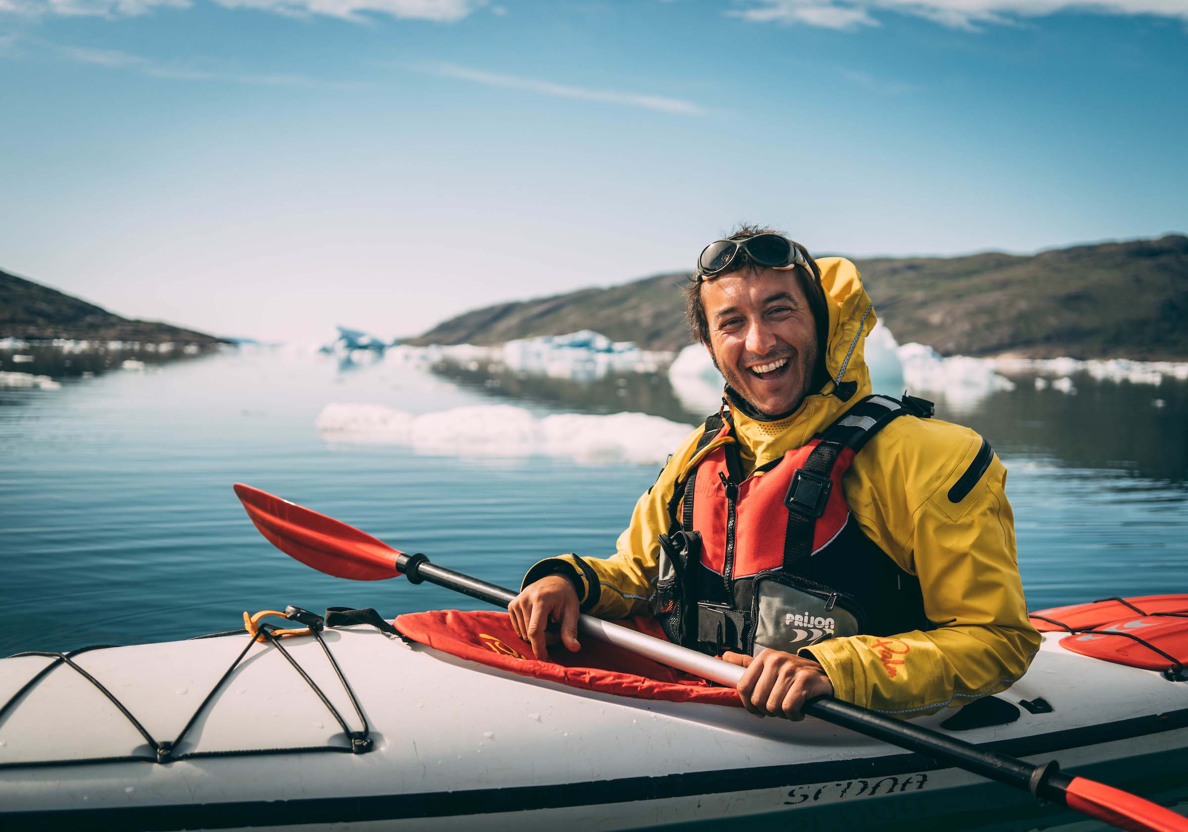 Smiling man on kayak. Photo - Jorgo Kokkinidis, Visit Greenland