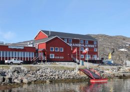 The Aasiaat Seamen’s Home from outside on a sunny day. Photo by Aasiaat Sømandshjem, Visit Greenland