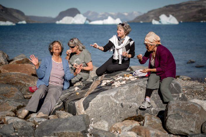 Four women sharing a meal on the rocks near Narsaq in South Greenland