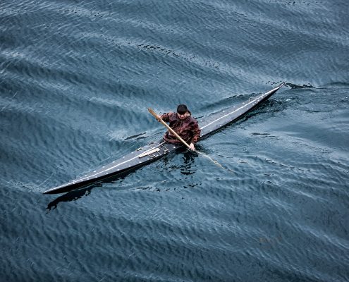 History - A kayaker from Sisimiut in Greenland in a traditional skin kayak