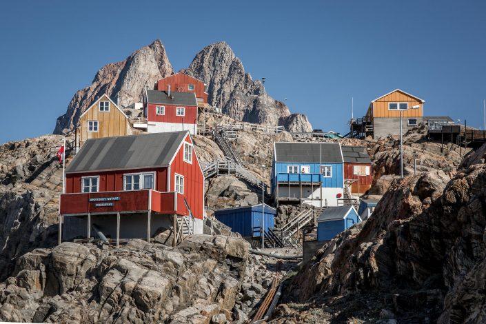 Houses on the hillside in Uummannaq in North Greenland with the prominent heat shaped mountain in the background