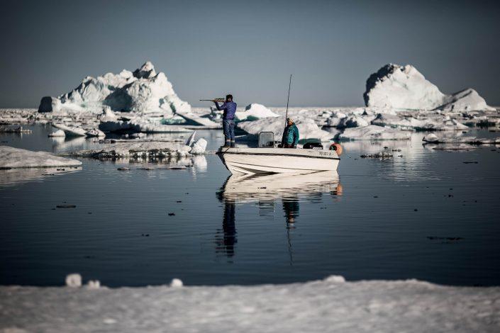 Hunting Culture - Two hunters in the sea ice near Tasiilaq in East Greenland