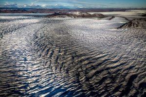 Lines in the ice sheet seen from an Air Zafari flight near Kangerlussuaq in Greenland. By Mads Pihl