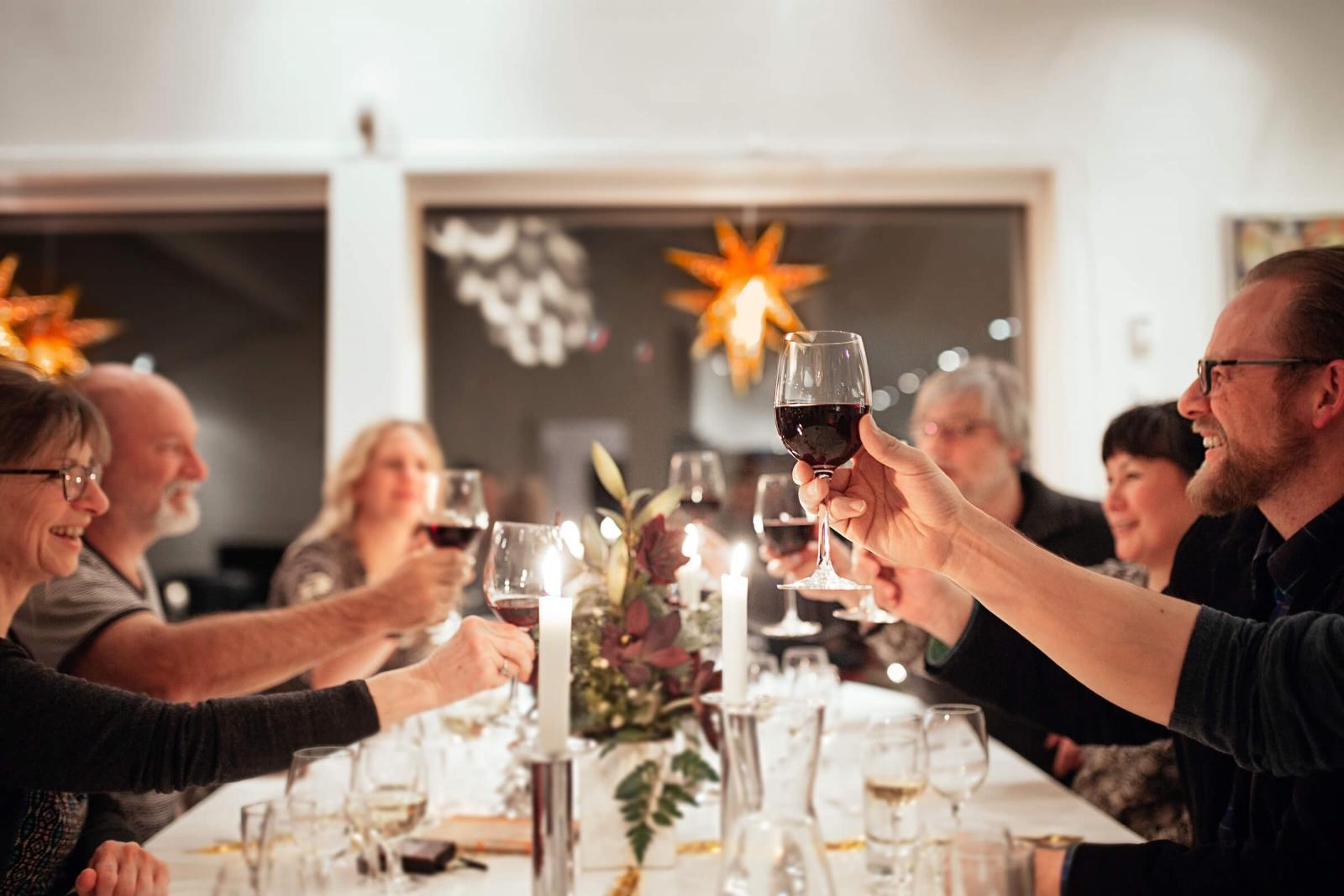 Locals and tourists sharing a toast during a christmas dinner in the Margrethe Suite in Nuuk in Greenland. Photo by Rebecca Gustafsson