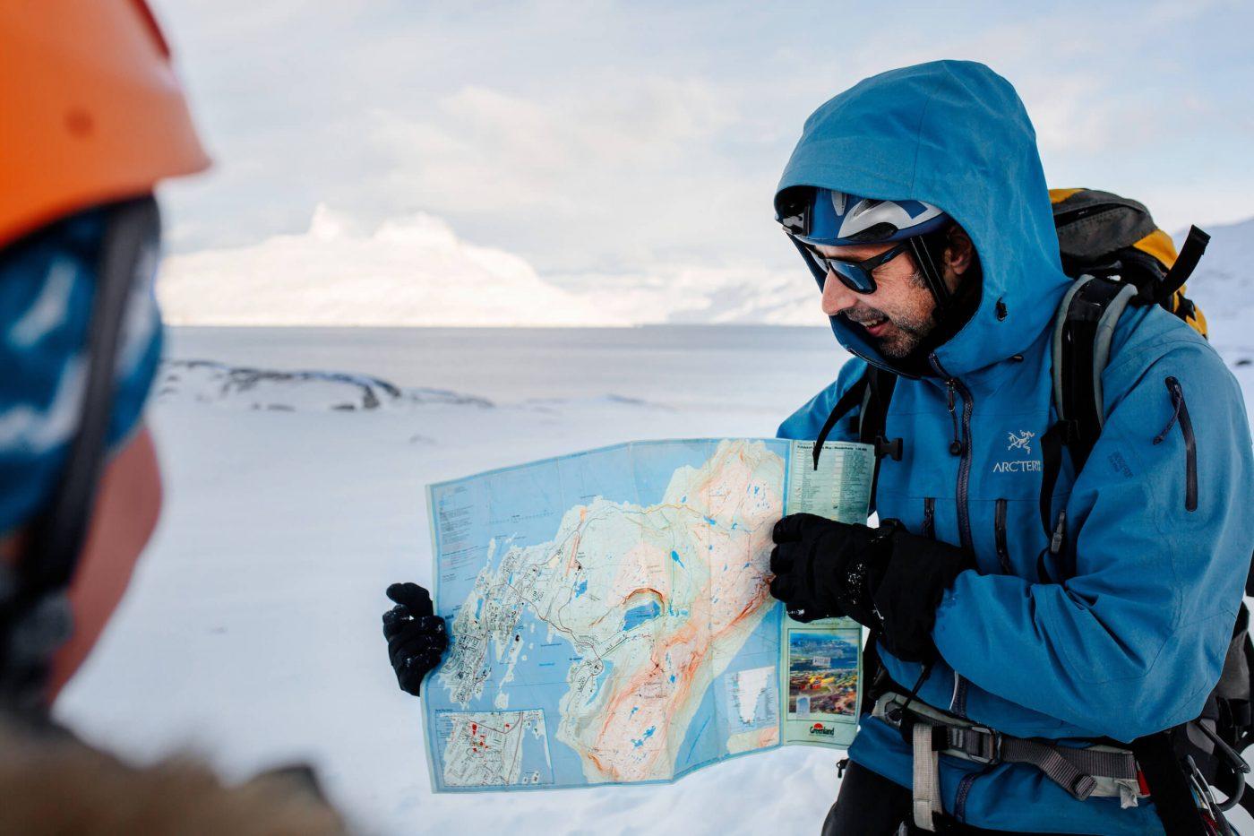 Mountain guide Marc Carreras showing hike route on Nuuk map in Greenland. By Rebecca Gustafsson