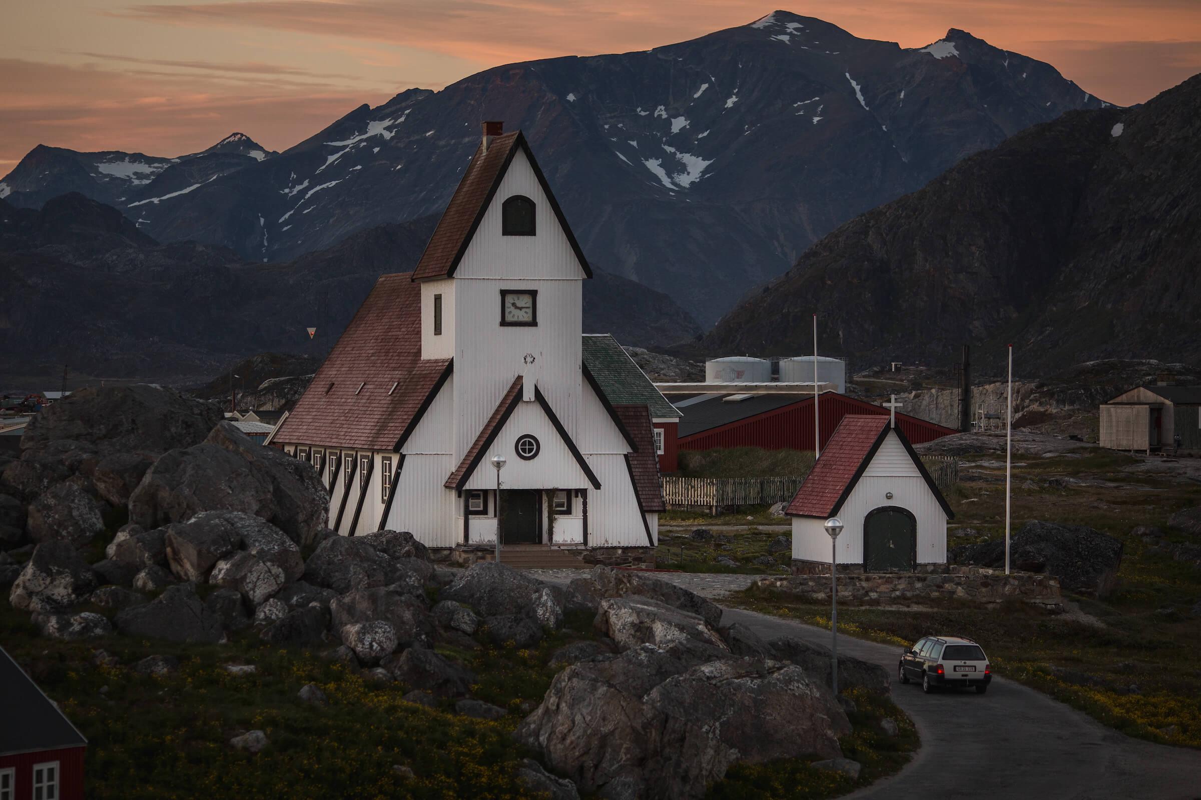 An evening view of the white church in Nanortalik in South Greenland. Photo by Mads Pihl - Visit Greenland