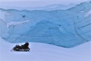 Photobreak on a snowmobile in front of glestcher in East Greenland. Photo by Tasiilaq Tours