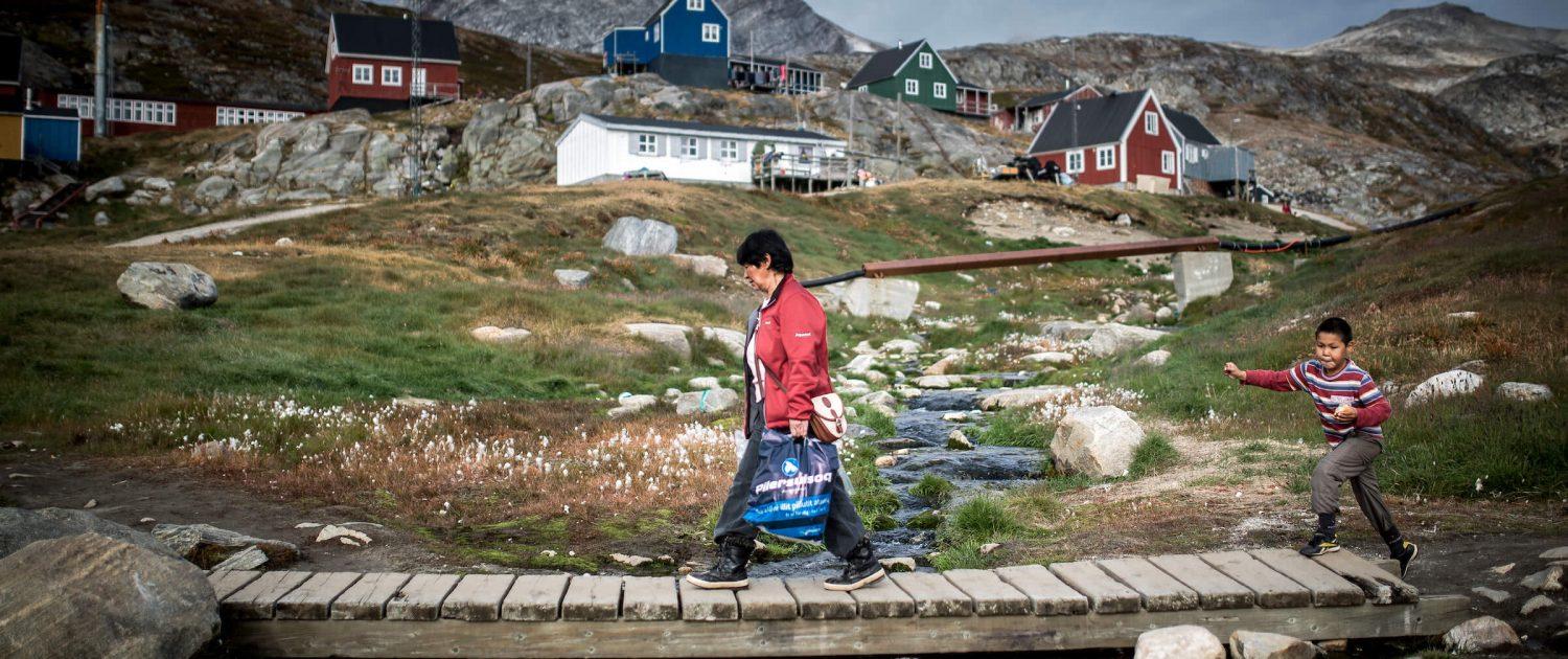 A mother and her son walking home from the grocery store Pilersuisoq in Kuummiut, East Greenland. By Mads Pihl