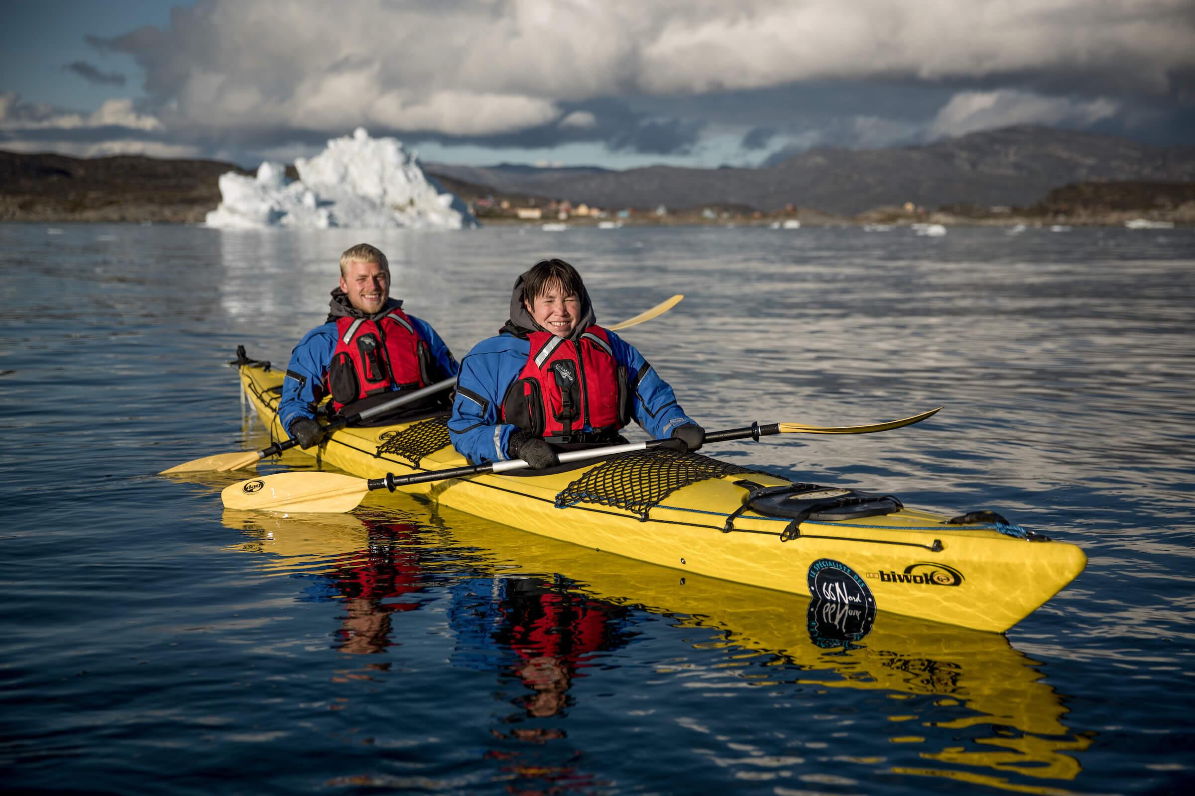 Two happy kayakers from PGI Greenland near Oqaatsut in Greenland. Photo by Mads Pihl.