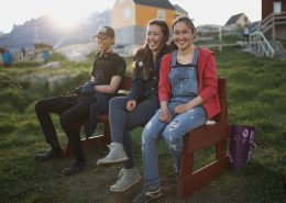 Three young people in the sunset in Ukkusissat, Greenland. Photo by Mads Pihl