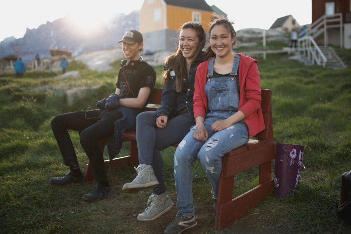 Three young people in the sunset in Ukkusissat, Greenland. Photo by Mads Pihl