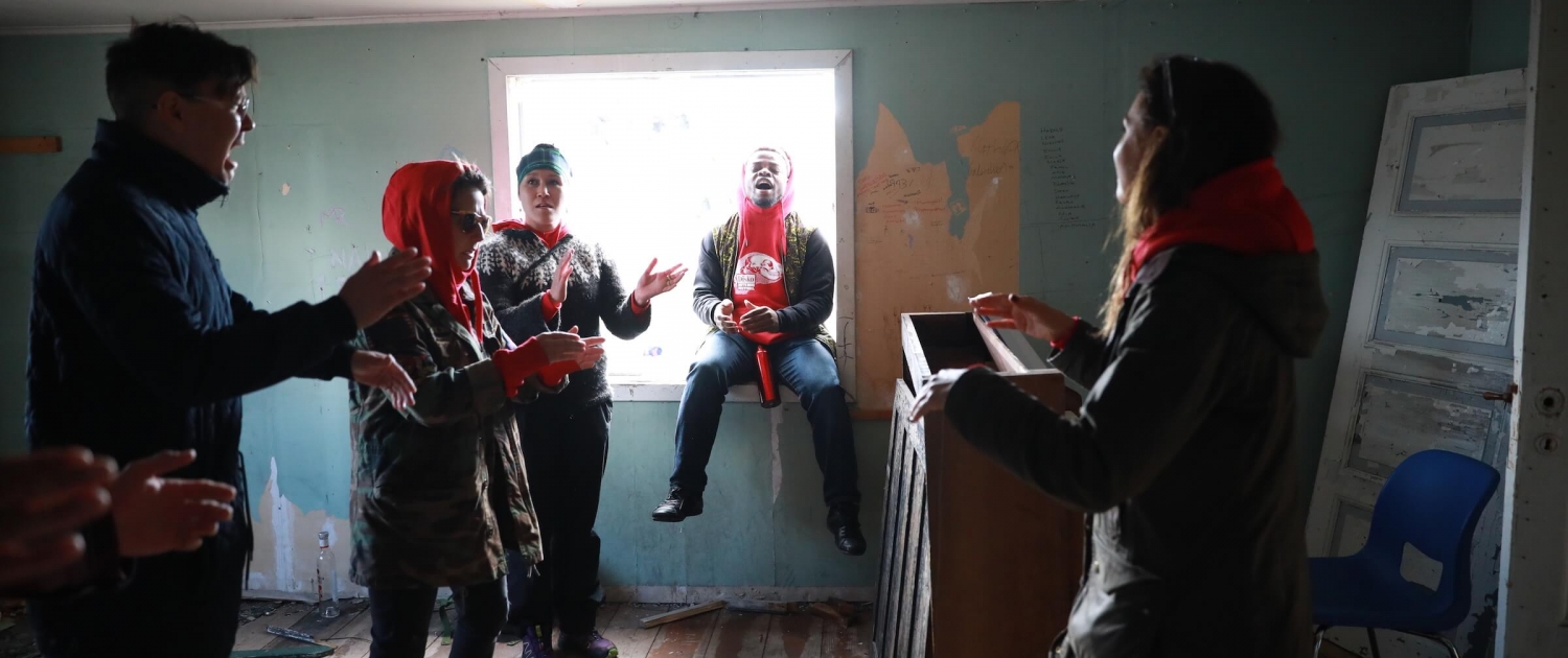 Artists sing Amazing Grace in the old Post House. Photo by Jessie Brinkman Evans - Visit Greenland
