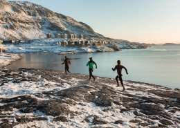 Three women running in a row in Qingorput in Nuuk in Greenland. Photo by Rebecca Gustafsson - Visit Greenland.