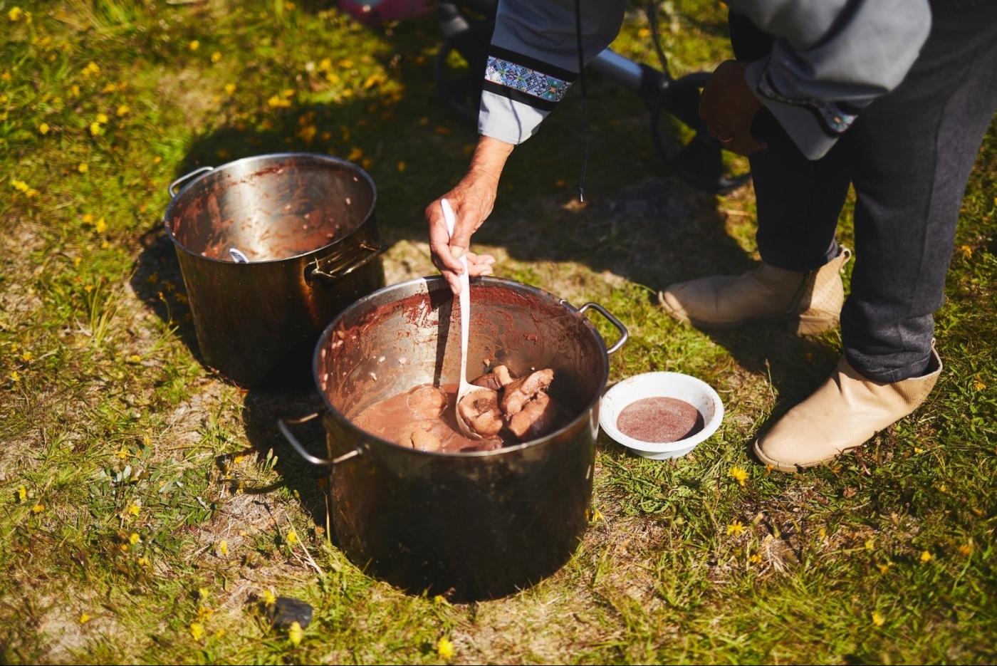 Seal soup served outside in Narsaq. Photo by Peter Lindstrom - Visit Greenland