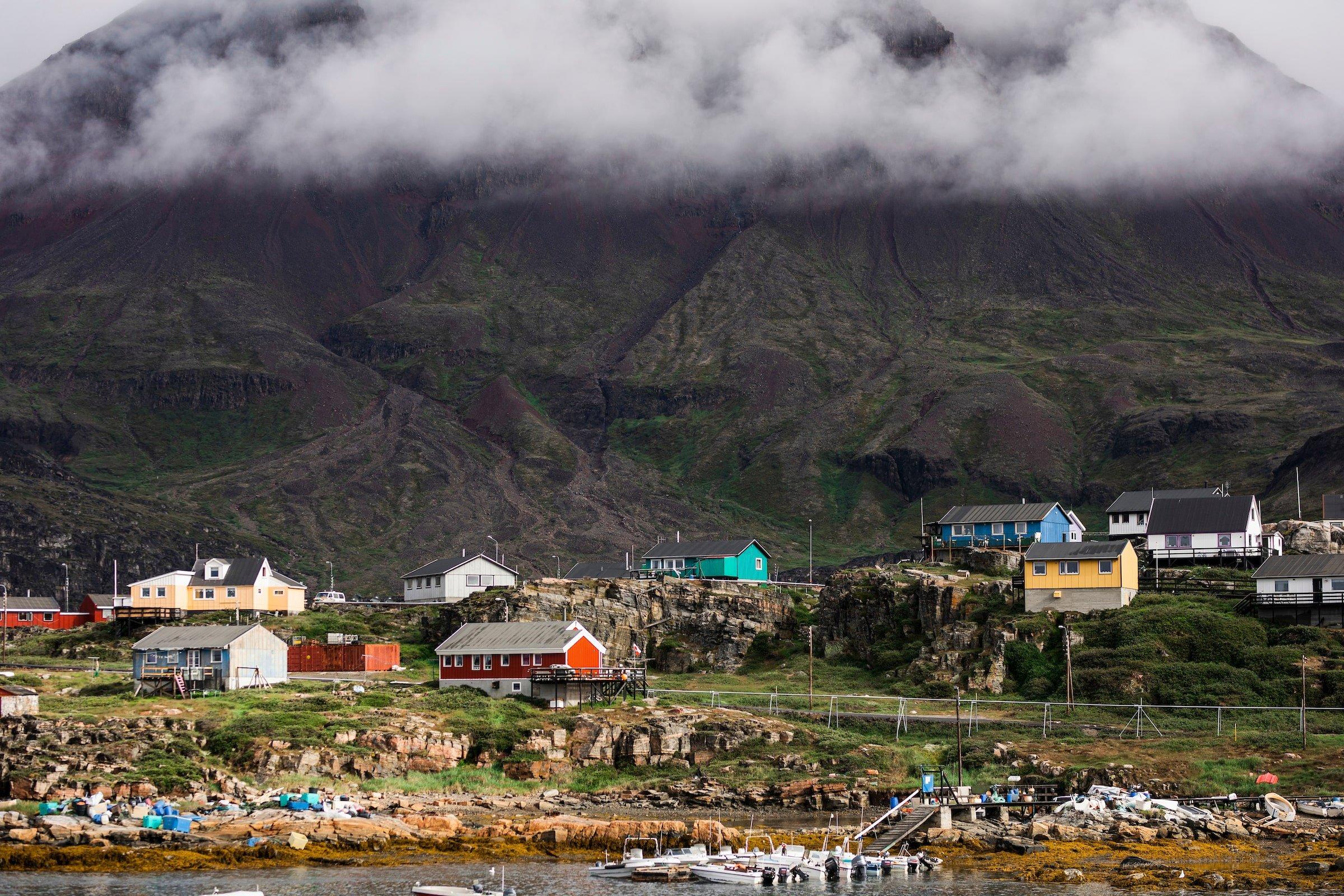 Qeqertarsuaq Houses and clouds. Aningaaq Rosing Carlsen - Visit Greenland