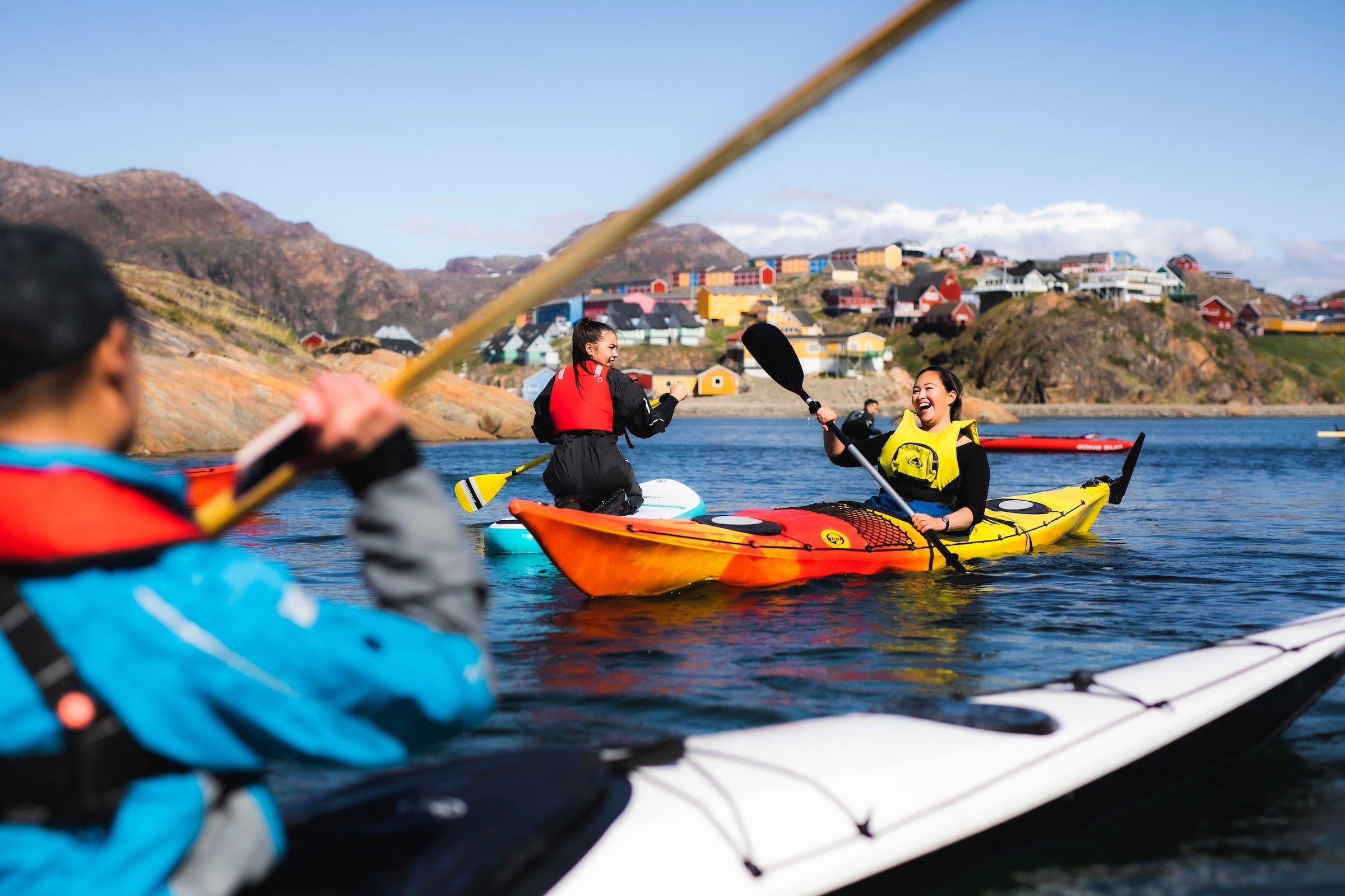 Tourists kayaking on a sunny day in Sisimiut.