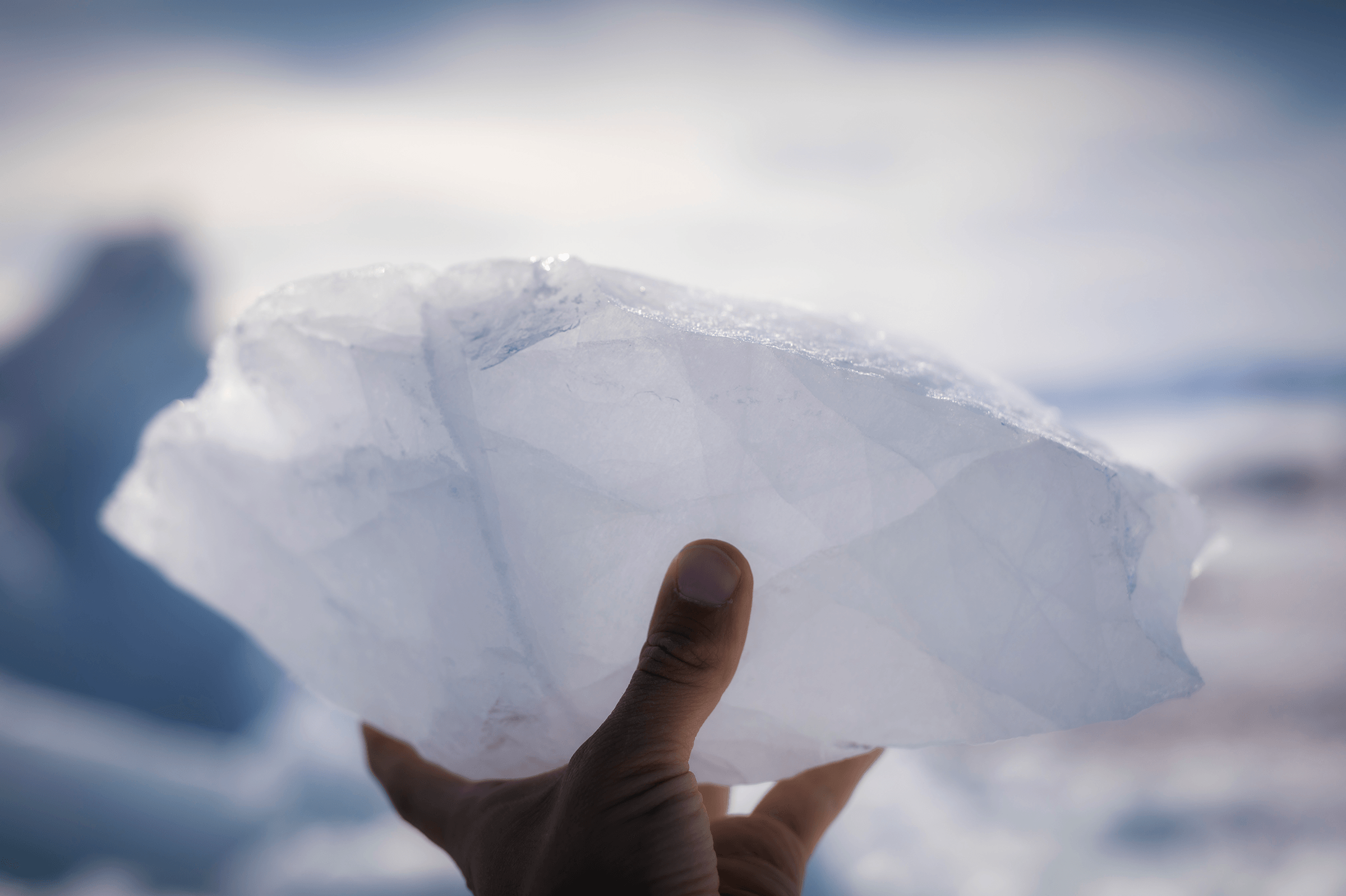 Chunk of ice in a hand. Photo by Aningaaq R Carlsen - Visit Greenland. png