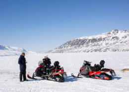 Two snowmobilers on pause in Sisimiut. Photo by Kim Insuk - Visit Greenland