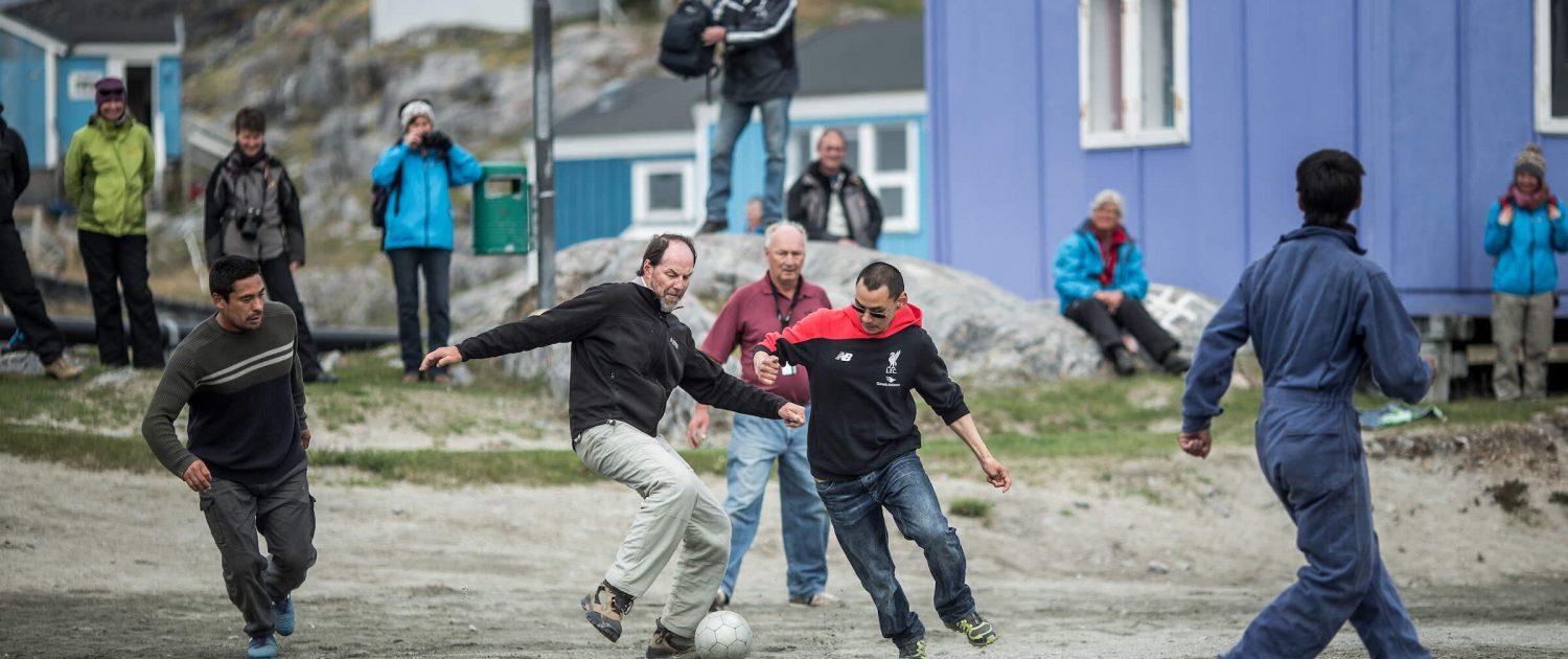 A game of soccer between cruise guests and Itilleq locals in Greenland. Photo by Mads Pihl