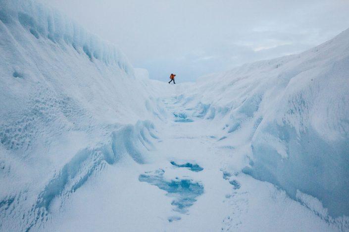 A glacier walking adventure by a crevasse on the Greenland Ice Sheet near Kangerlussuaq. By Paul Zizka